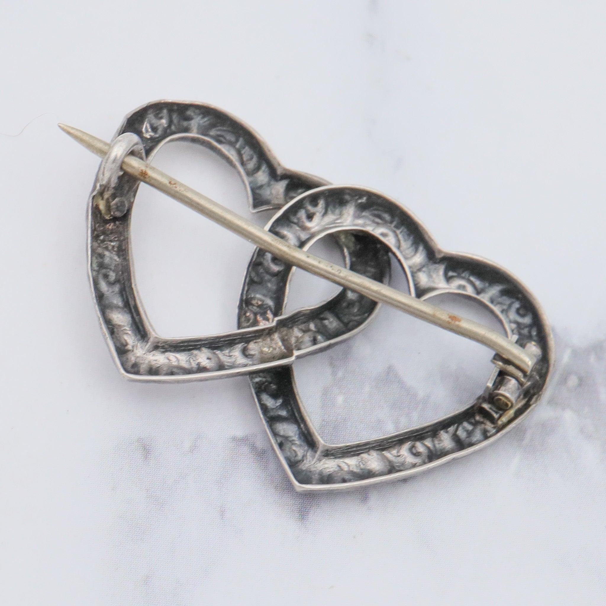 Antique Victorian sterling repousse double heart brooch